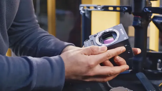 A person holding Sony's Venice Extension System Mini, a compact modular camera sensor unit for flexible cinematography.